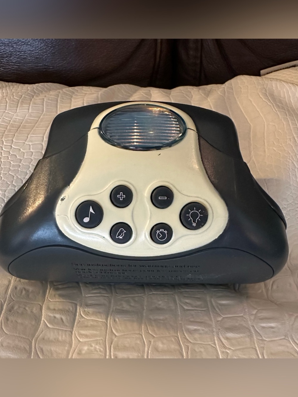 Graco Pack 'n Play Soother with soft Lights, music, and sounds.